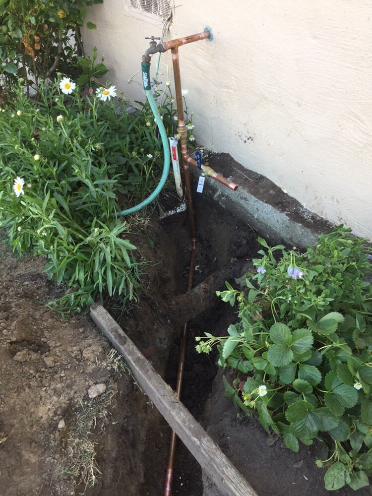Plumber's trench showing a new copper water service line
