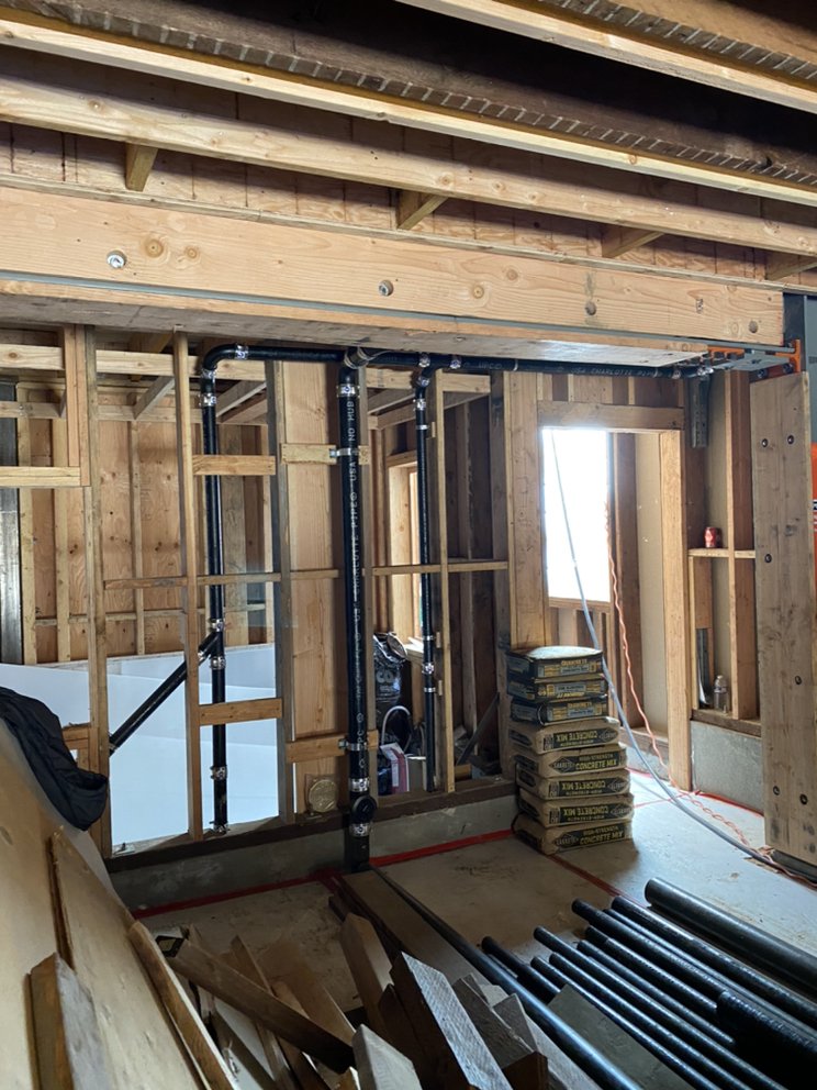 Plumber's whole-house repipe rough-in on new construction framing